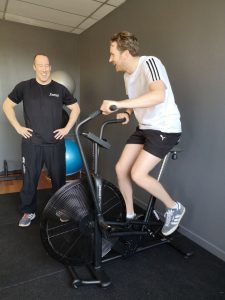 Young Man on Air bike Smiling. Perth Fitness Classes Scotland